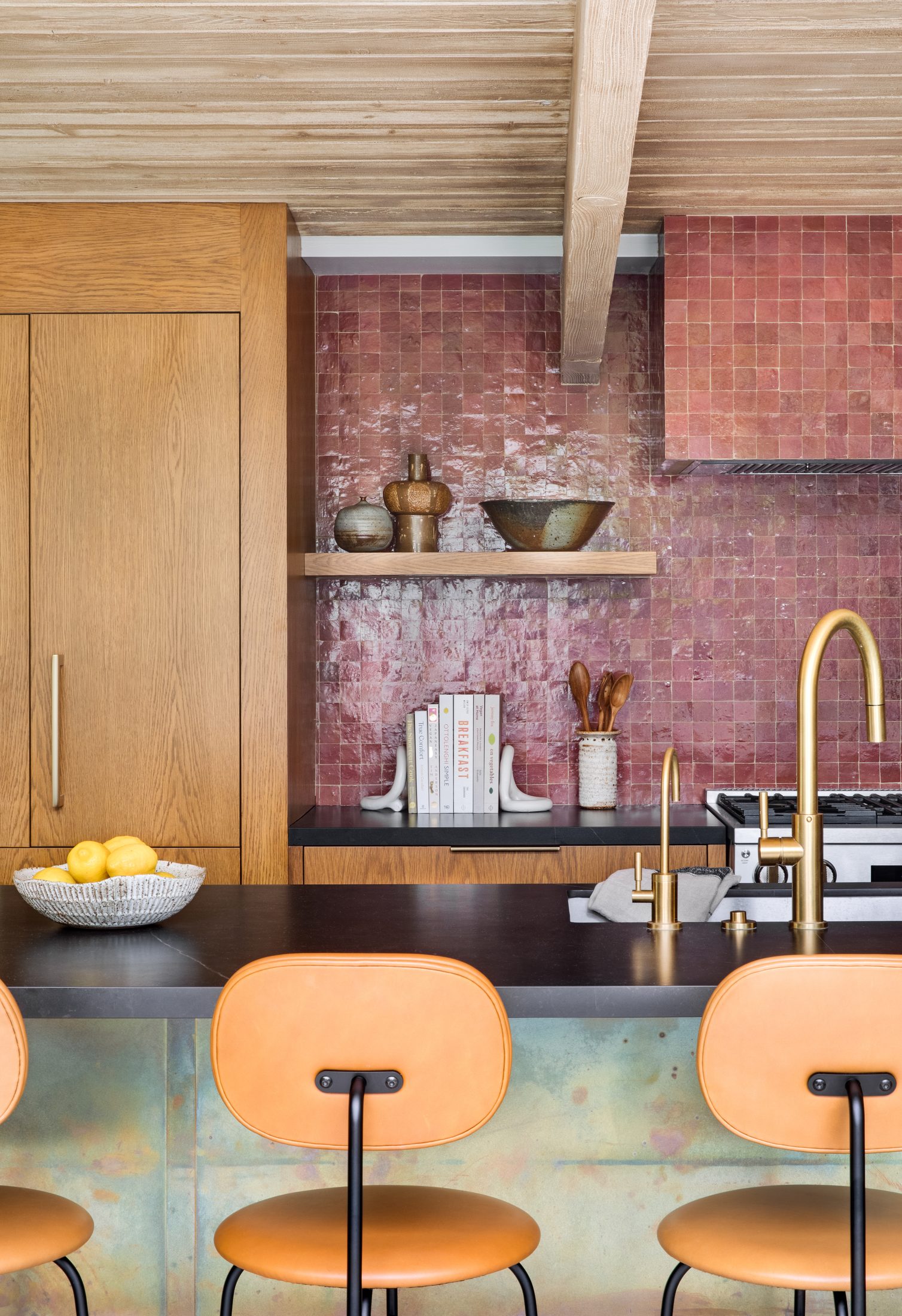 Kitchen bar seating in front of a pink zellige backsplash