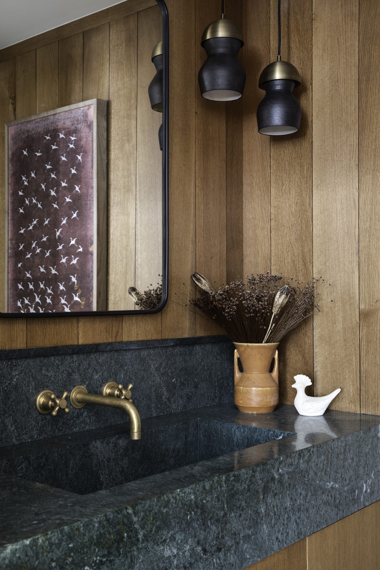 Powder room with soapstone trough sink and oak paneling