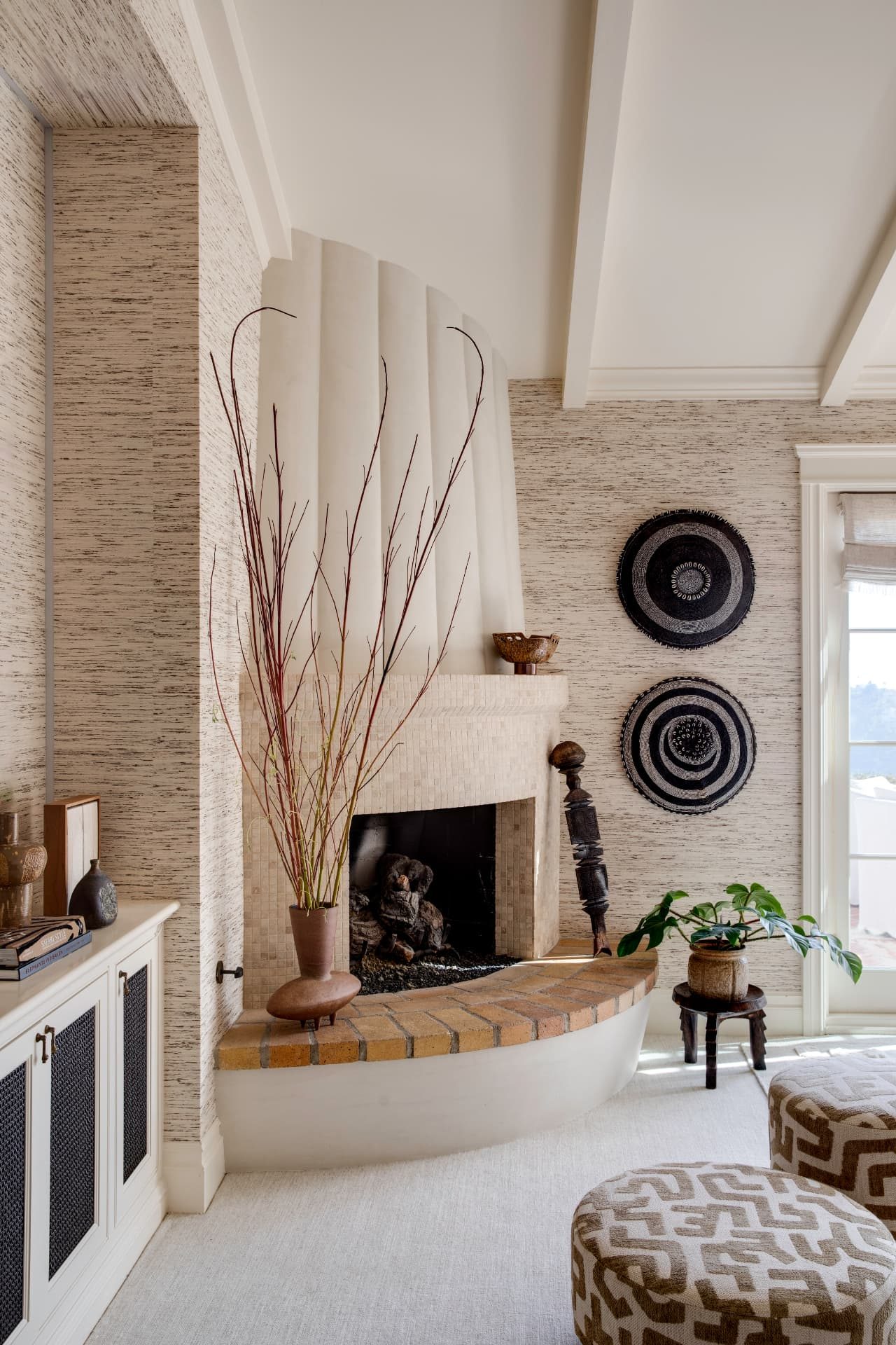 Sculpted plaster fireplace with mosaic surround and woven wall baskets
