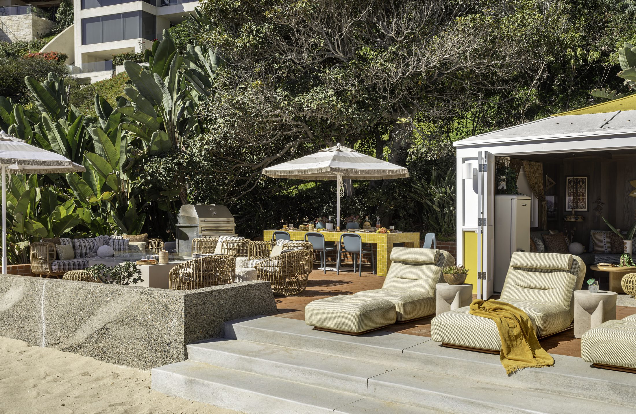 Terrace lounge with cream chaises and a yellow tiled bar