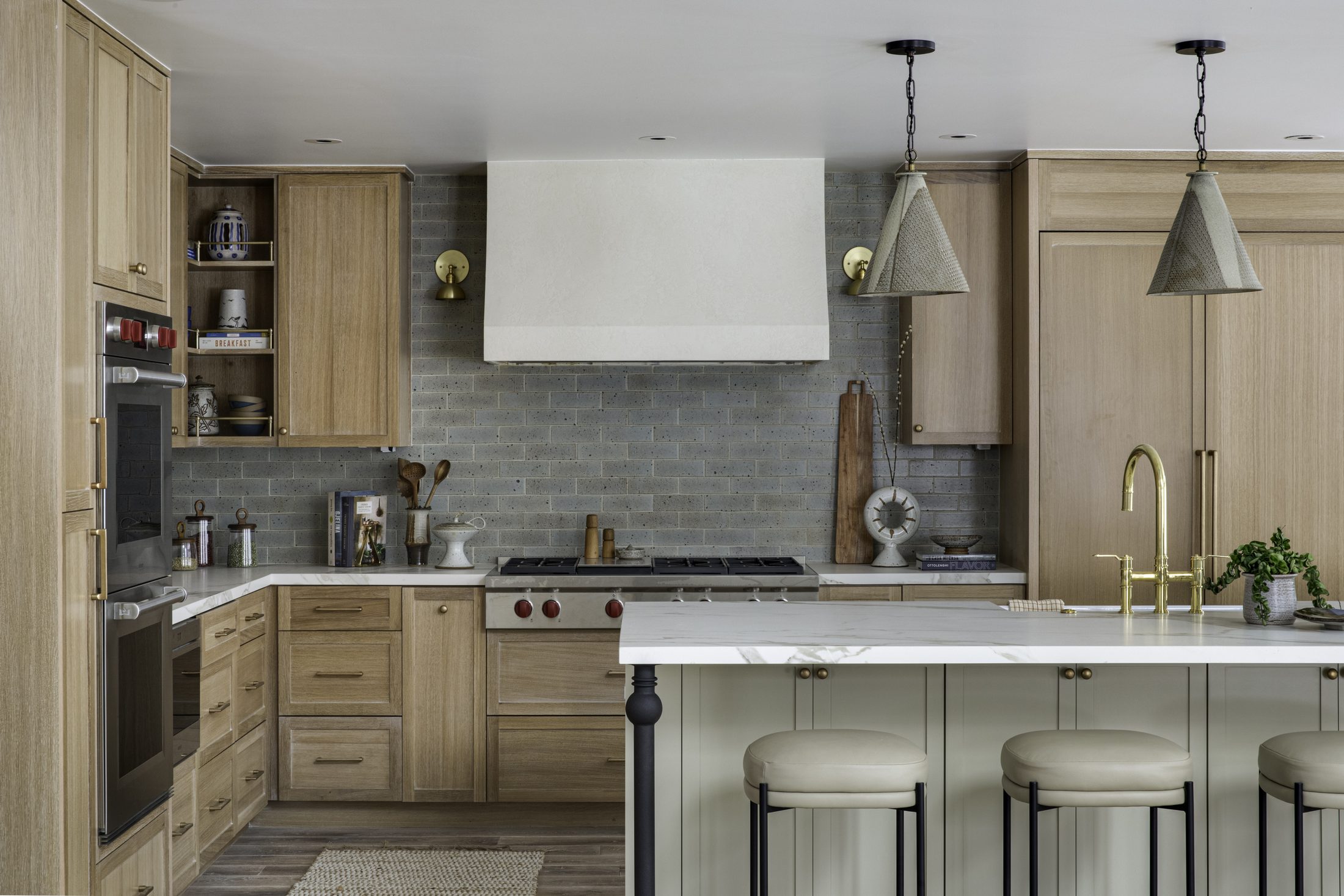 Kitchen with pale oak cabinetry and blue-grey tile backsplash