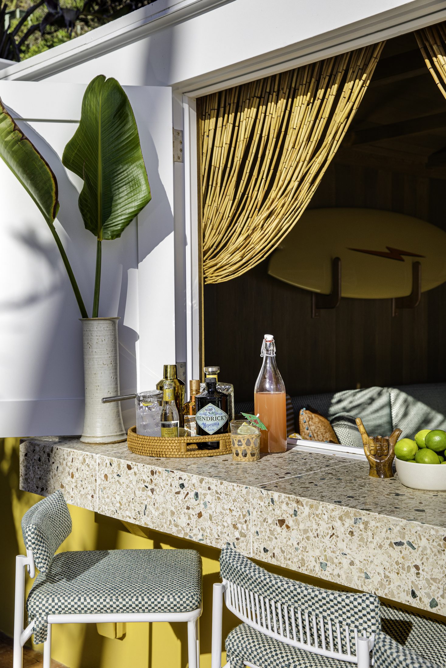 Terrazzo bar counter with drinks tray and gold curtain backdrop