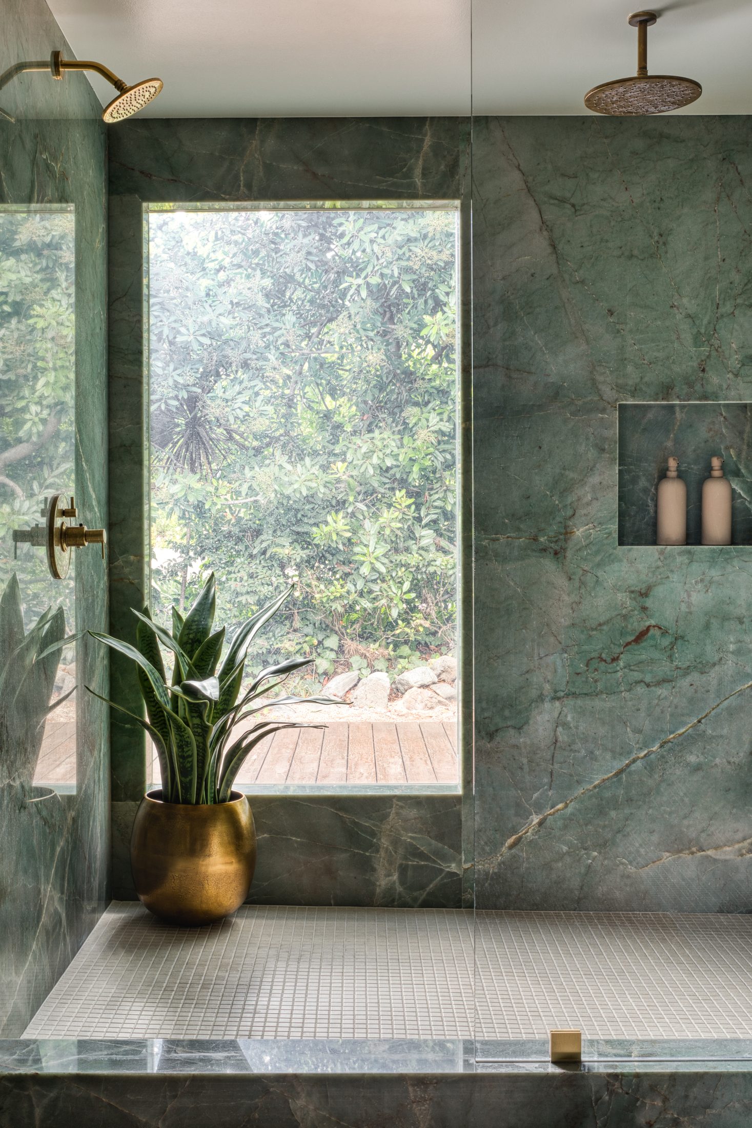 Shower niche framed in book-matched green marble