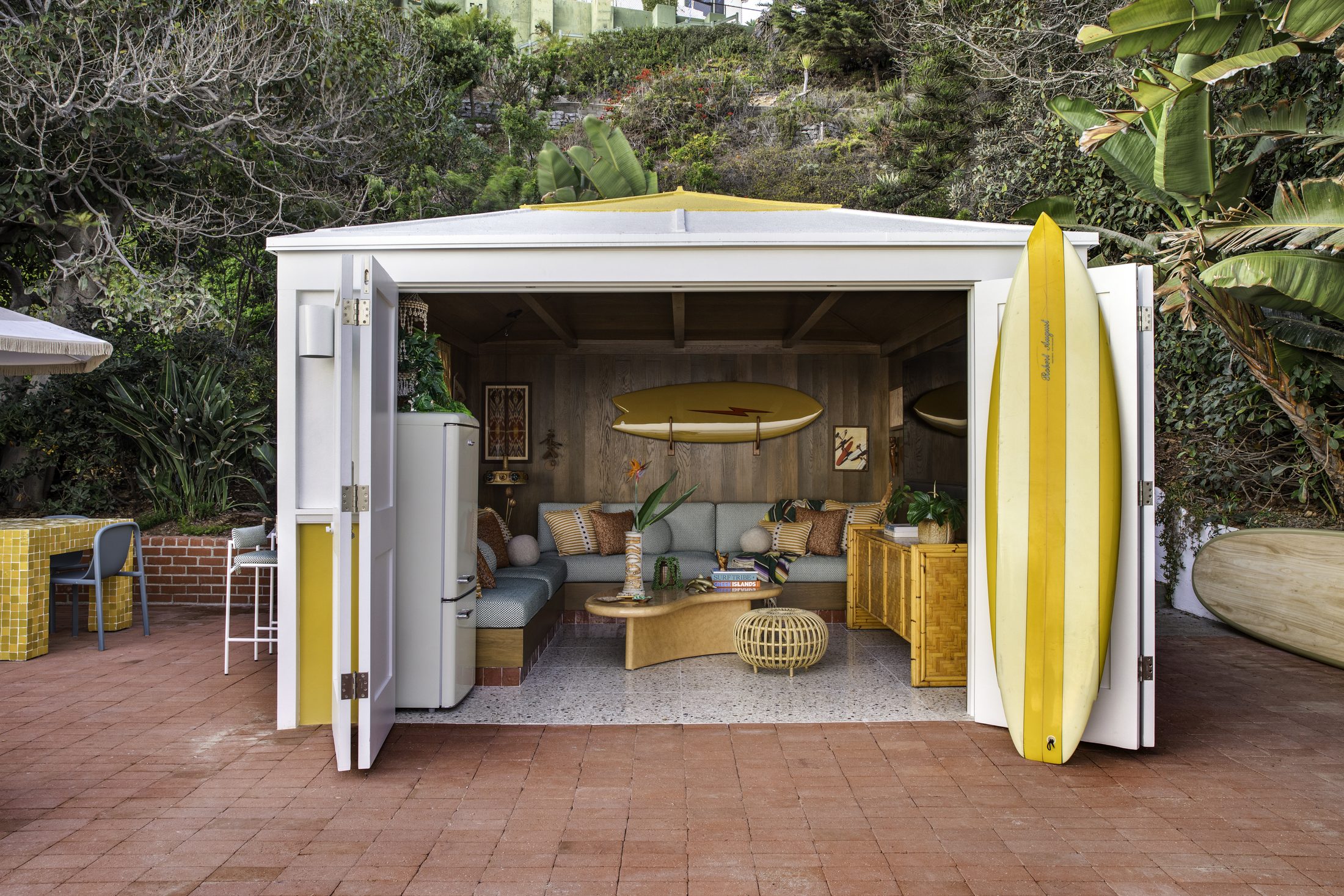 Cabana doors thrown open to the terracotta terrace
