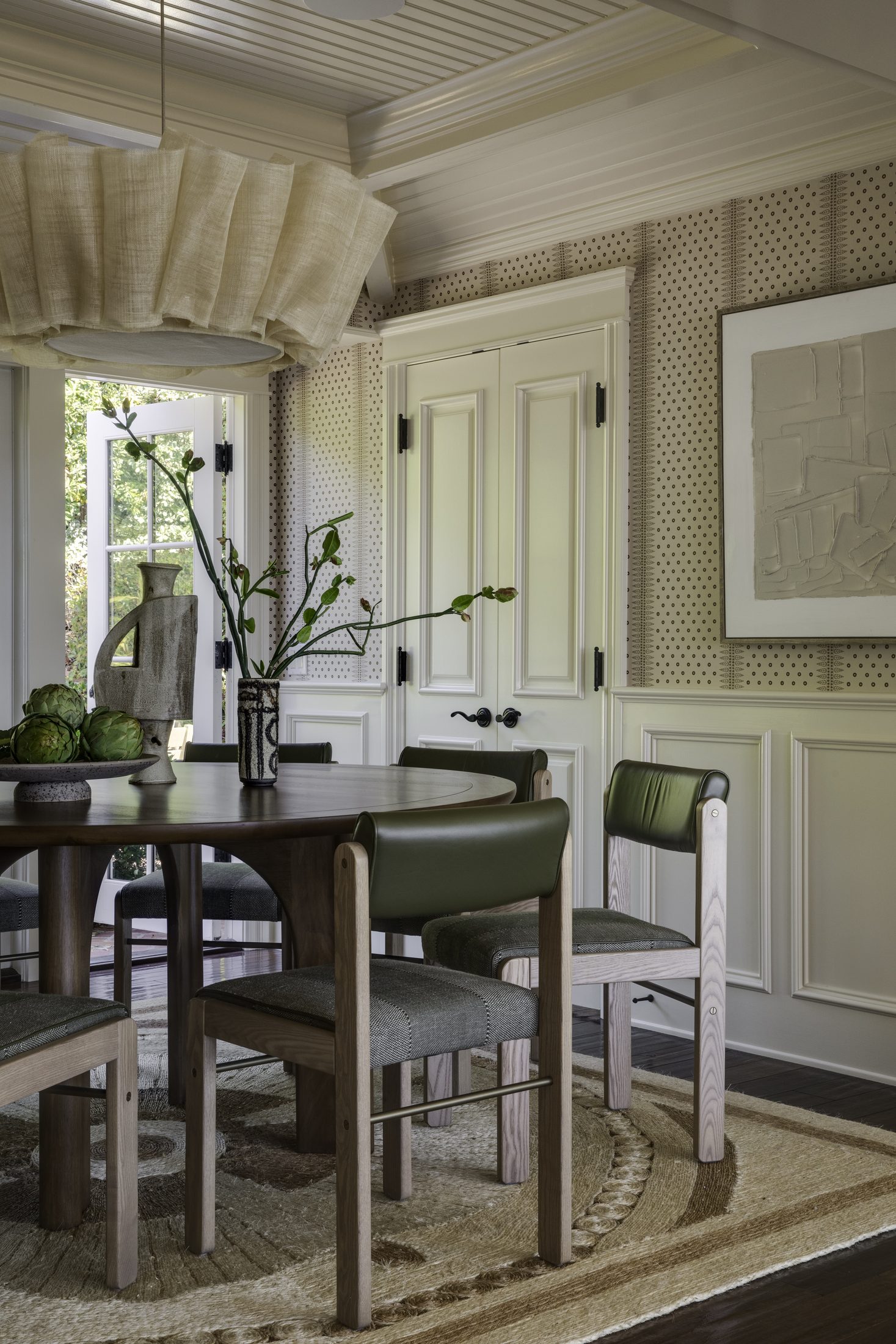Breakfast room with a dark round table and paneled millwork