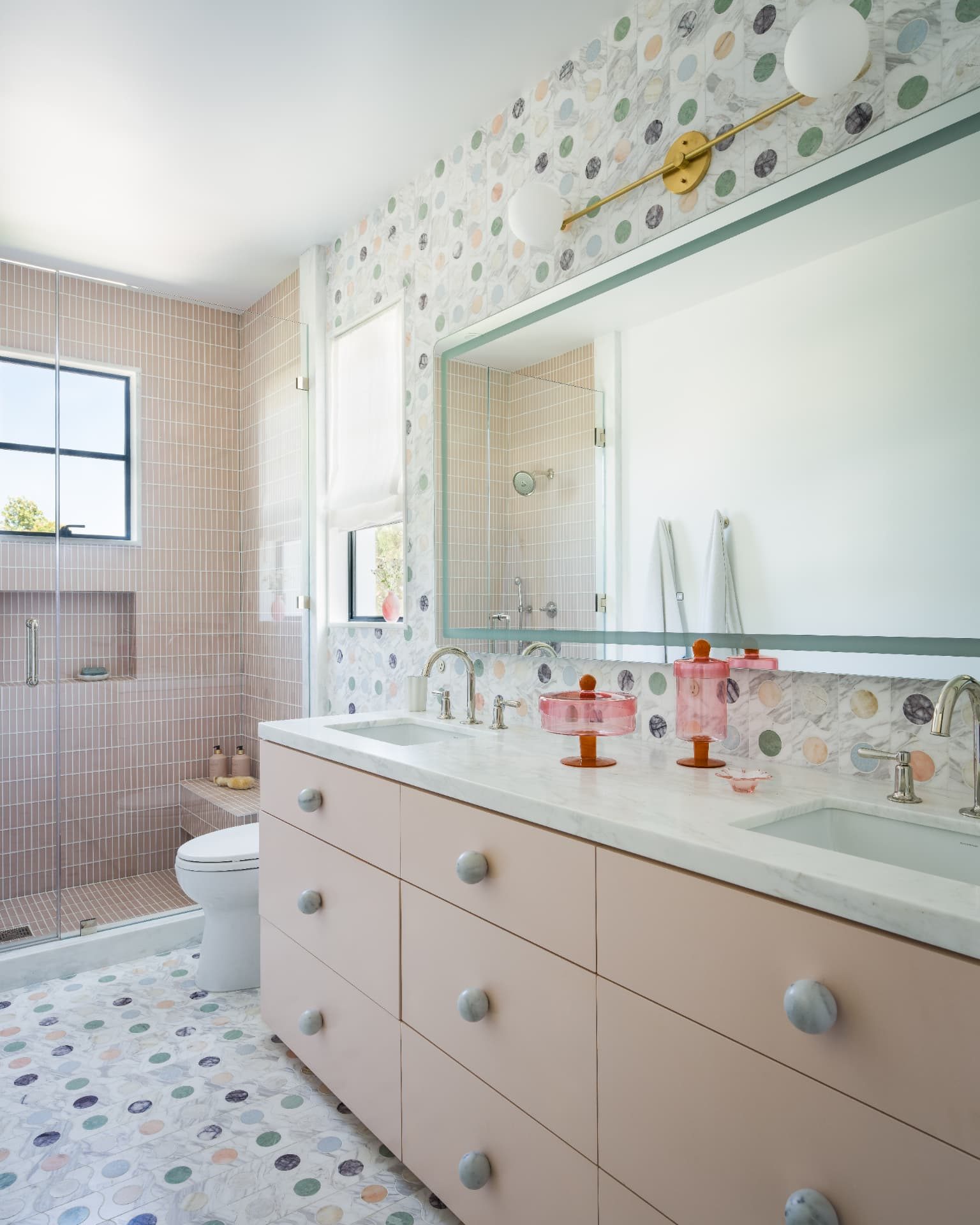 Children's bath in pink tile with a confetti marble mosaic floor