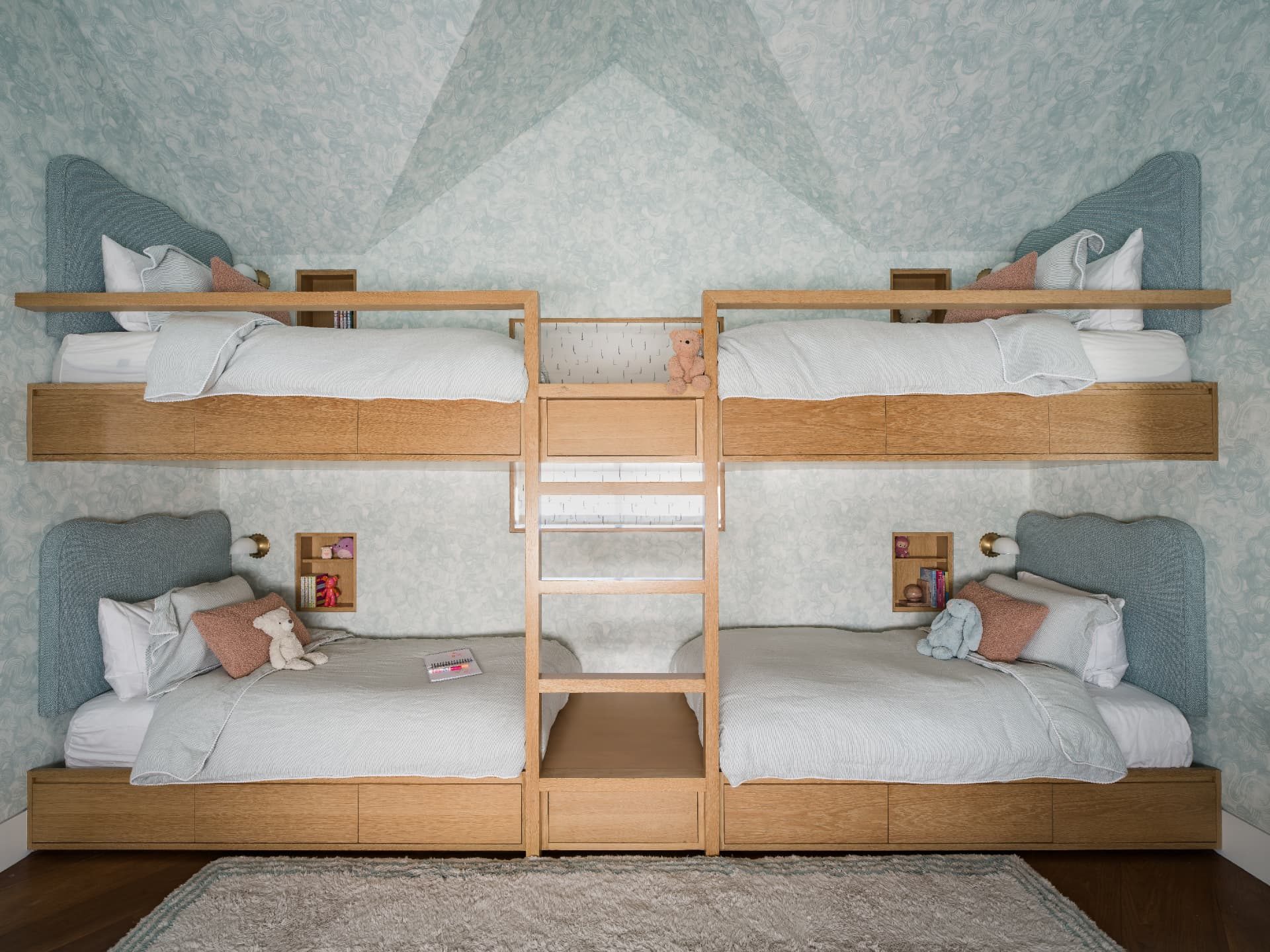 Four-bed bunk room in pale oak with soft green marbled wallpaper