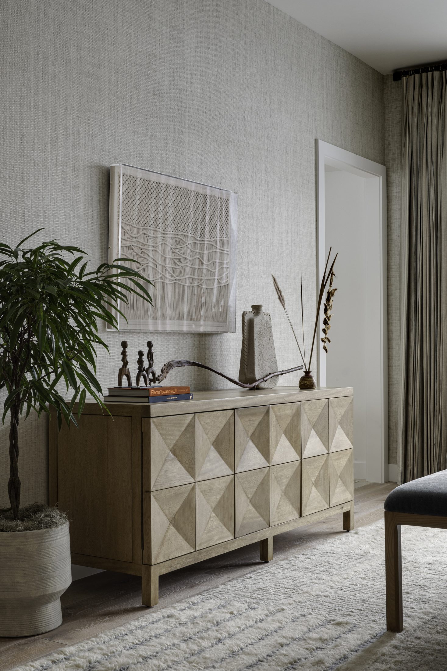 Bedroom dresser vignette with graphic art and dried grasses
